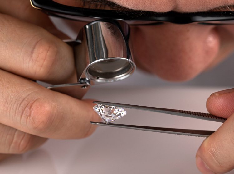 Man looking close up at diamond