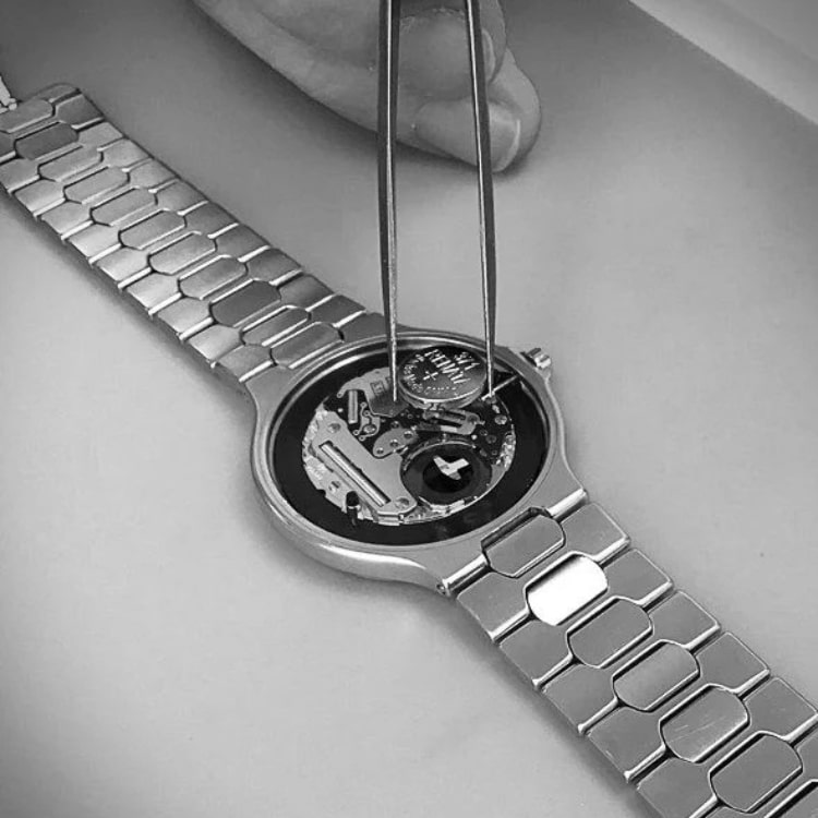Quartz watch battery being replaced