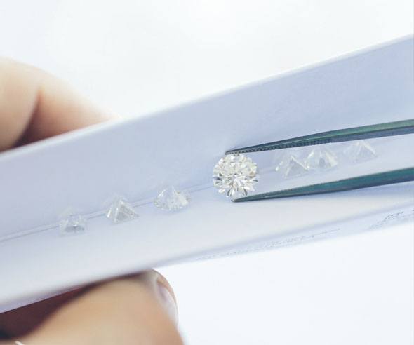 Diamond being held by tweezers