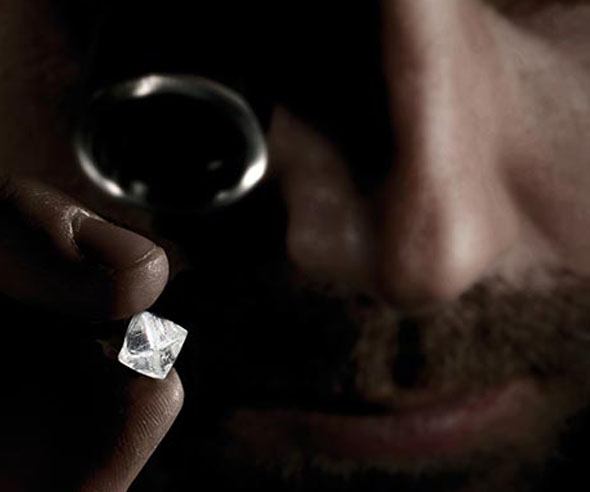 Man inspecting a diamond
