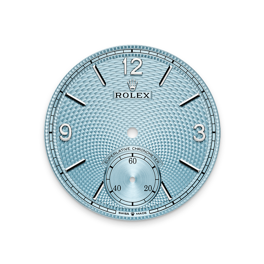 The ice blue dial features a guilloché rice-grain motif. This rosette-like design is distinctive for its three-dimensional, repeating geometric pattern that extends across the surface of the dial starting from the small seconds counter at 6 o’clock. The minute track is surrounded by a filet sauté with crimped pattern, which is also guilloché. With the introduction of a dial created via guillochage, or engine turning – a technique that uses a turning tool to sculpt a pattern into a surface – Rolex is pursuing the course it has set for the Perpetual collection as a tribute to the classic art of watchmaking infused with the brand’s know-how and creativity. This exclusive dial bears the same Arabic numerals 3, 9 and 12, the same faceted hour markers and the same hands as that of the 18 ct gold versions. 

This exclusive dial colour can be found only on the Day-Date, the Cosmograph Daytona and the Perpetual 1908.