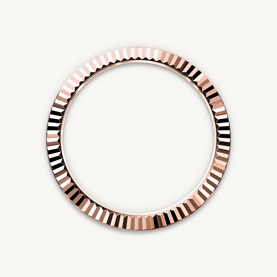 The Rolex fluted bezel is a mark of distinction. Originally, the fluting of the Oyster bezel had a functional purpose: it served to screw the bezel onto the case, helping to ensure the waterproofness of the watch. It was therefore identical to the fluting on the case back, which was also screwed onto the case for waterproofness, using specific Rolex tools. Over time, the fluting became an aesthetic element, a genuine Rolex signature feature. Today the fluted bezel is a mark of distinction, always in gold. The Sky-Dweller is equipped with a mechanism of interaction between the rotatable bezel, the winding crown and the movement: the Ring Command system, which allows the user to select the watch's functions one-by-one and to set them easily, quickly and securely.