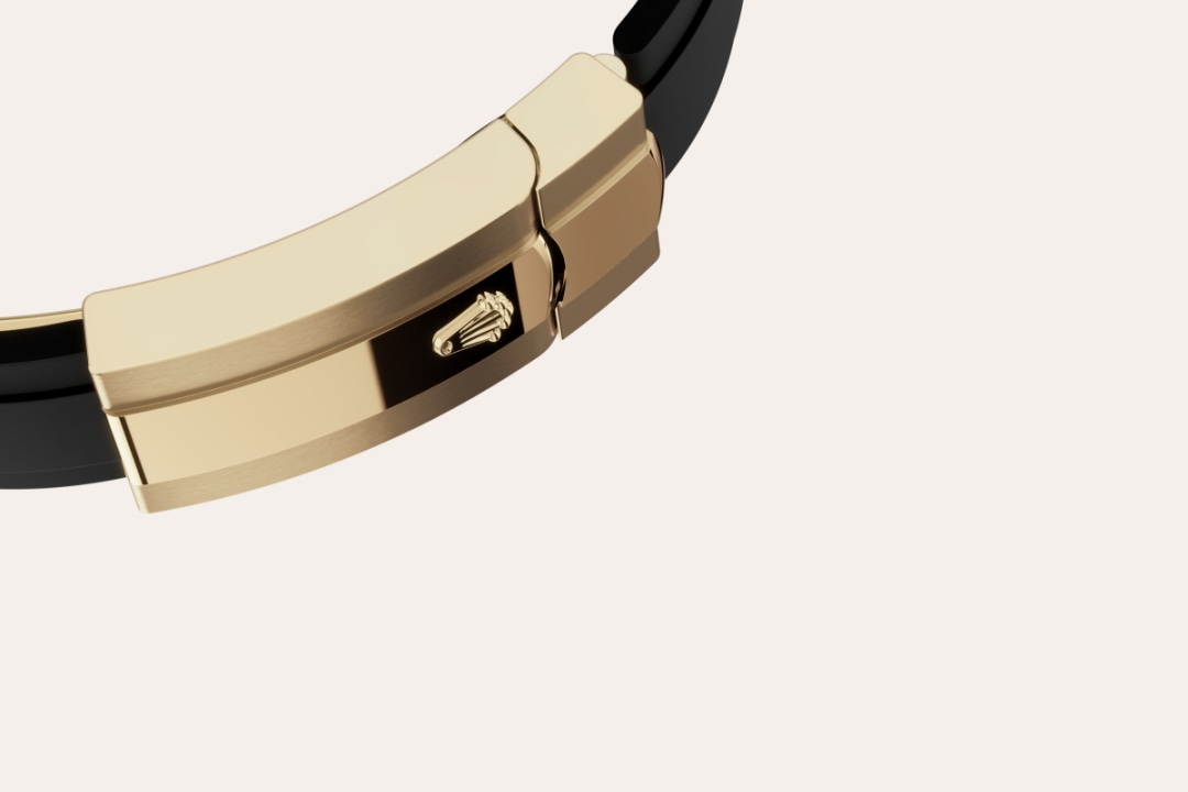 The Sky-Dweller’s new Oysterflex bracelet, developed by Rolex and patented, offers a sporty alternative to metal bracelets. The bracelet attaches to the watch case and the Oysterclasp by a flexible titanium and nickel alloy metal blade. The blade is overmoulded with high-performance black elastomer which is particularly resistant to environmental effects, very durable and perfectly inert for the wearer of the watch. For enhanced comfort, the inside of the Oysterflex bracelet is equipped with a patented longitudinal cushion system that stabilizes the watch on the wrist and fitted with an 18 ct yellow gold Oysterclasp. It also features the Rolex Glidelock extension system, designed by the brand and patented. This inventive toothed mechanism, integrated beneath the clasp, allows fine adjustment of the bracelet length by some 15 mm in increments of approximately 2.5 mm, without the use of tools.