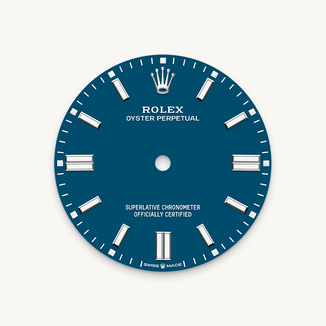 The colours created for the Oyster Perpetual range start life as a lacquer, which must be meticulously applied in a controlled-atmosphere environment to avoid dust and other contamination. The brass plate of the dial base receives layer upon layer of lacquer, six in all, to form a regular, uniform surface. The last step is varnishing and polishing to bring out the full brilliance and depth of colour. The various inscriptions are then pad printed, and the hour markers and crown riveted by hand. The dial, gleaming in its perfection, is all set to take its place on top of the movement at the watch assembly phase.