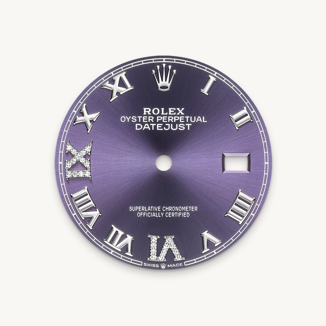 This dial features a Roman VI and IX in 18 ct gold, set with 24 diamonds. The sunray finish creates delicate light reflections on many dials in the Oyster Perpetual collection. It is obtained using masterful brushing techniques that create grooves running outwards from the centre of the dial. Light is diffused consistently along each engraving, creating a characteristic subtle glow that moves depending on the position of the wrist. Once the sunray finish has been completed, the dial colour is applied using Physical Vapour Deposition or electroplating. A light coat of varnish gives the dial its final look.