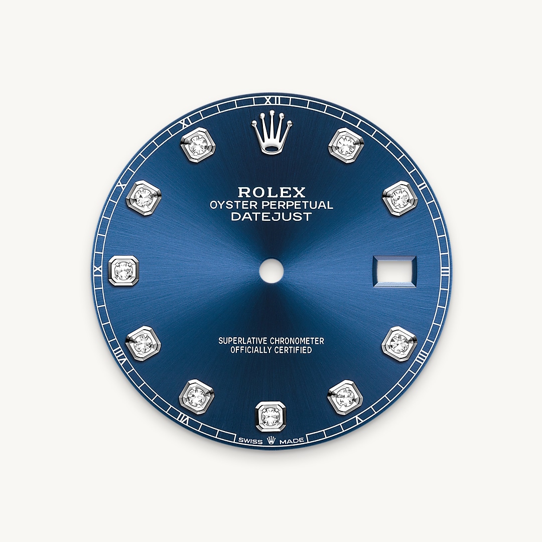 This dial features diamonds in 18 ct gold settings. The sunray finish creates delicate light reflections on many dials in the Oyster Perpetual collection. It is obtained using masterful brushing techniques that create grooves running outwards from the centre of the dial. Light is diffused consistently along each engraving, creating a characteristic subtle glow that moves depending on the position of the wrist. Once the sunray finish has been completed, the dial colour is applied using Physical Vapour Deposition or electroplating. A light coat of varnish gives the dial its final look.