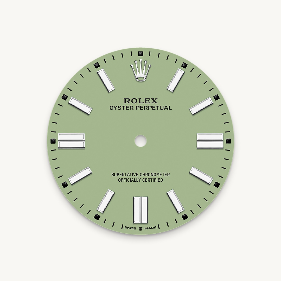 The colours created for the Oyster Perpetual range start life as a lacquer, which must be meticulously applied in a controlled-atmosphere environment to avoid dust and other contamination. The brass plate of the dial base receives layer upon layer of lacquer, six in all, to form a regular, uniform surface. The last step is varnishing and polishing to bring out the full brilliance and depth of colour. The various inscriptions are then pad printed, and the hour markers and crown riveted by hand. The dial, gleaming in its perfection, is all set to take its place on top of the movement at the watch assembly phase.