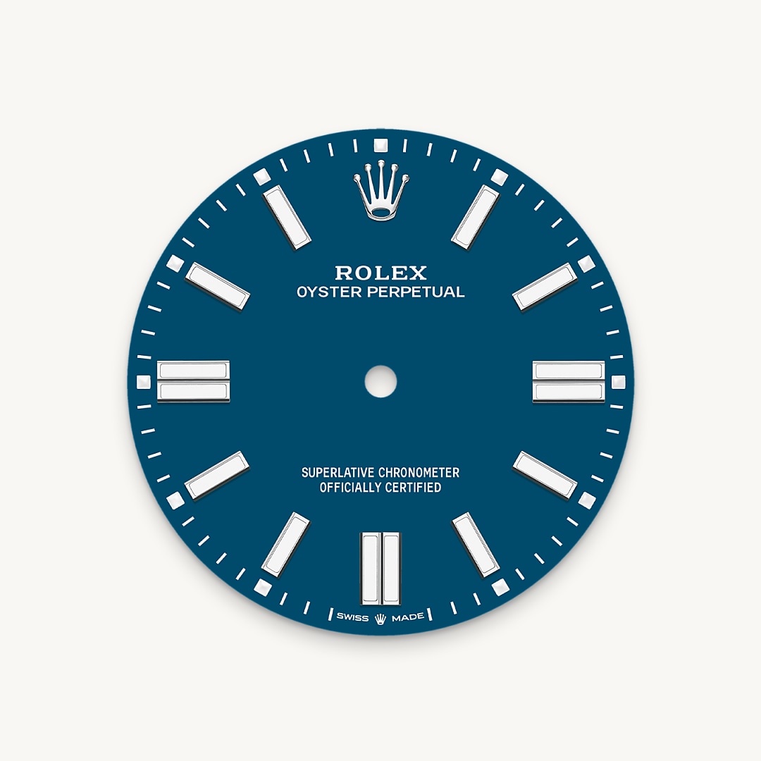 The colours created for the Oyster Perpetual range start life as a lacquer, which must be meticulously applied in a controlled-atmosphere environment to avoid dust and other contamination. The brass plate of the dial base receives layer upon layer of lacquer, six in all, to form a regular, uniform surface. The last step is varnishing and polishing to bring out the full brilliance and depth of colour. The various inscriptions are then pad printed, and the hour markers and crown riveted by hand. The dial, gleaming in its perfection, is all set to take its place on top of the movement at the watch assembly phase.