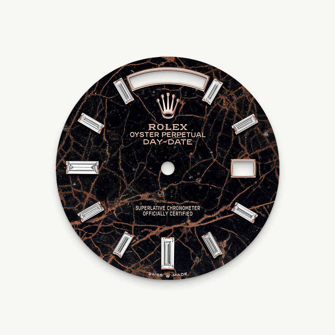This dial features 10 baguette-cut diamonds. The Oyster Perpetual Day-Date 40 is presented with a dial made from eisenkiesel, a deep brown decorative stone used by the brand for the first time in 2021. Eisenkiesel is an iron-oxide, delicately veined quartz. The stone discs destined for the dials are cut from a block of raw material. Only those whose colour and structure fully satisfy the brand’s exacting aesthetic requirements are selected. They will grace the dial of a Rolex watch, conferring it with a unique personality.