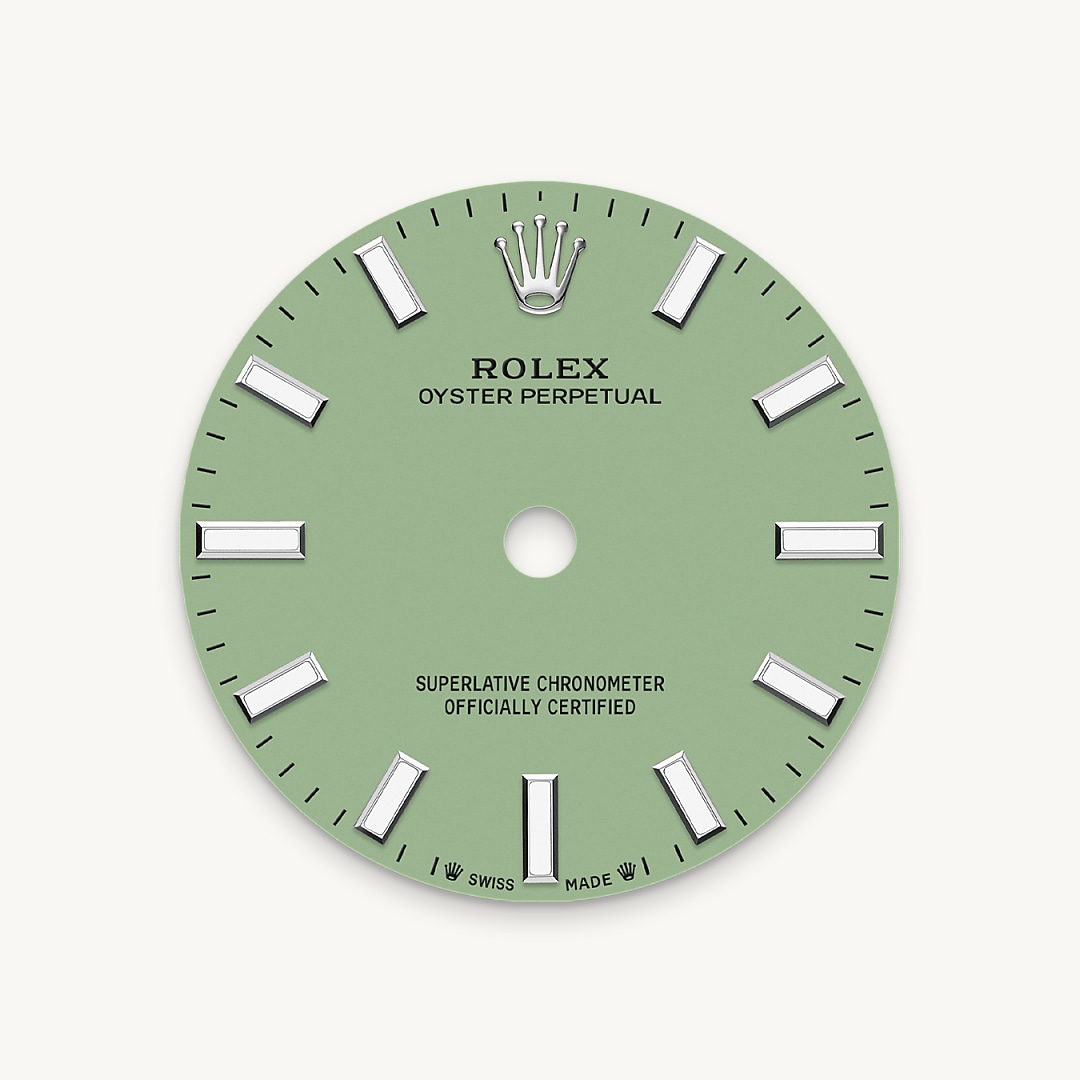 The colours created for the Oyster Perpetual range start life as a lacquer, which must be meticulously applied in a controlled-atmosphere environment to avoid dust and other contamination. The brass plate of the dial base receives layer upon layer of lacquer, six in all, to form a regular, uniform surface. The last step is varnishing and polishing to bring out the full brilliance and depth of colour. The various inscriptions are then pad printed, and the hour markers and crown riveted by hand. The dial, gleaming in its perfection, is all set to take its place on top of the movement at the watch assembly phase.