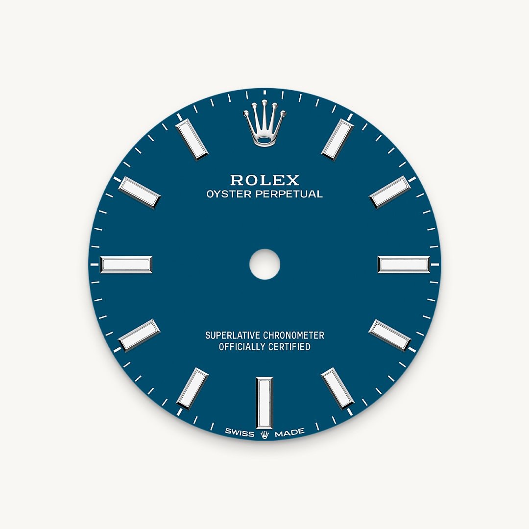 The colours created for the Oyster Perpetual range start life as a lacquer, which must be meticulously applied in a controlled-atmosphere environment to avoid dust and other contamination. The brass plate of the dial base receives layer upon layer of lacquer, six in all, to form a regular, uniform surface. The last step is varnishing and polishing to bring out the full brilliance and depth of colour. The various inscriptions are then pad printed, and the hour markers and crown riveted by hand. The dial, gleaming in its perfection, is all set to take its place on top of the movement at the watch assembly phase.