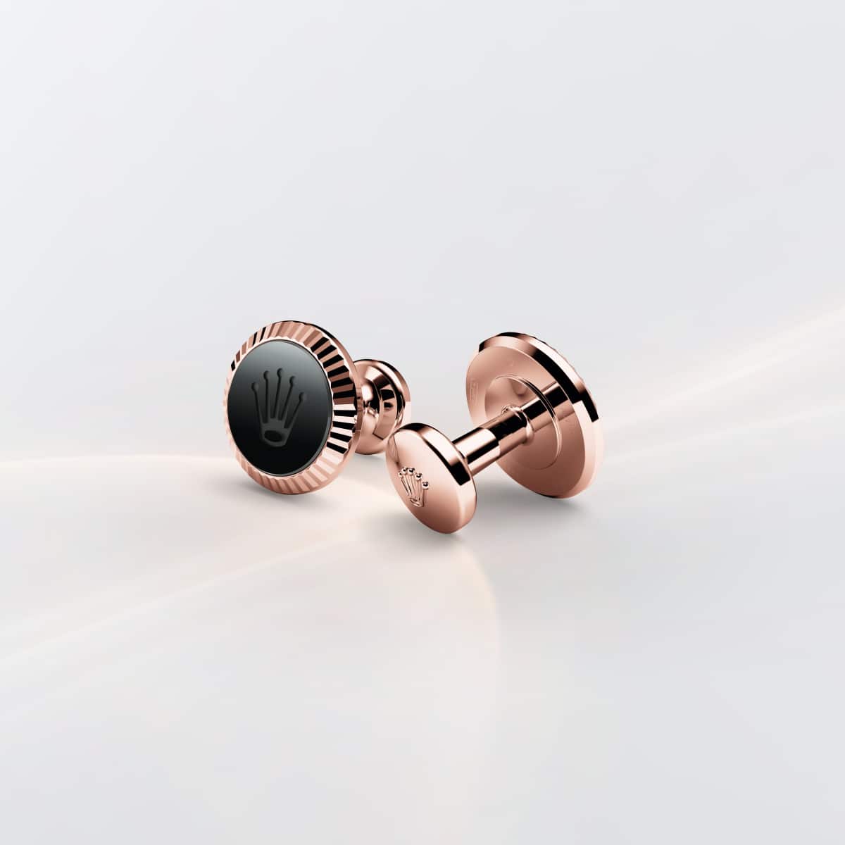 Rolex cufflinks made of 18 ct Everose gold featuring the signature Rolex fluting, Cerachrom insert and Rolex crown.