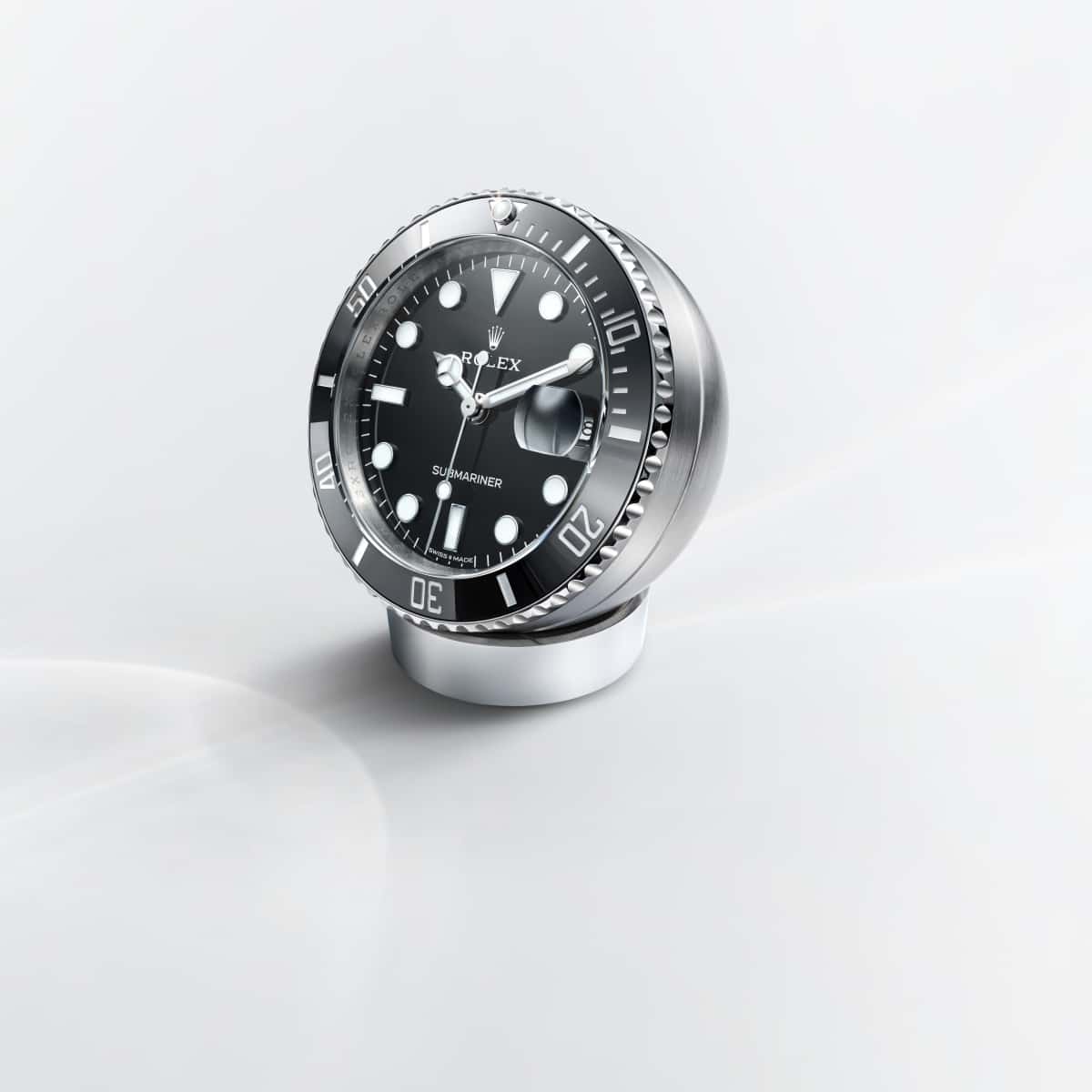 The Submariner desk clock in stainless steel, with a Cerachrom bezel insert and Chromalight display, incorporates a secular calendar.
